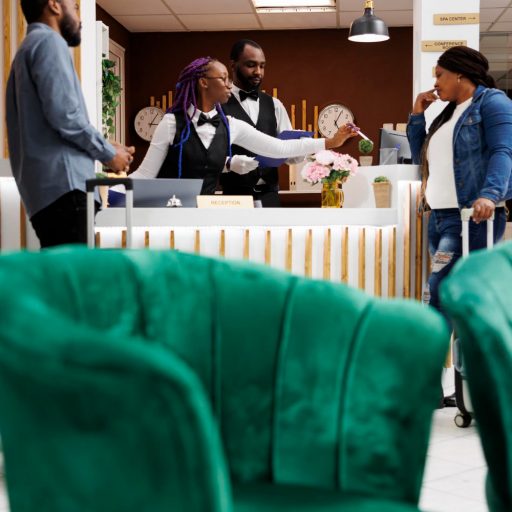 young-african-american-couple-arriving-hotel-standing-reception-with-baggage-talking-with-receptionist-while-checking-front-desk-agent-getting-information-about-guests-during-check